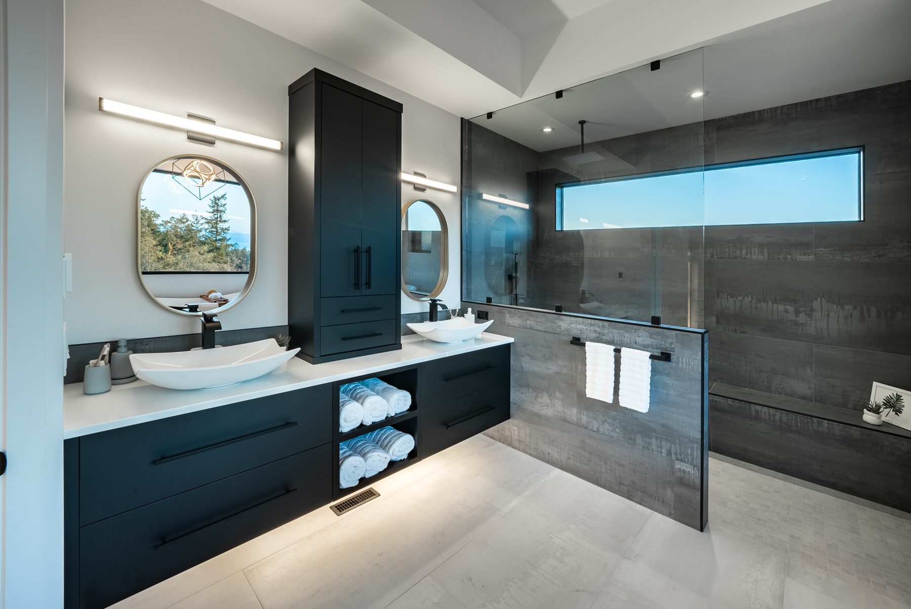 Renovated bathroom vanity with a stone counter and black fixtures