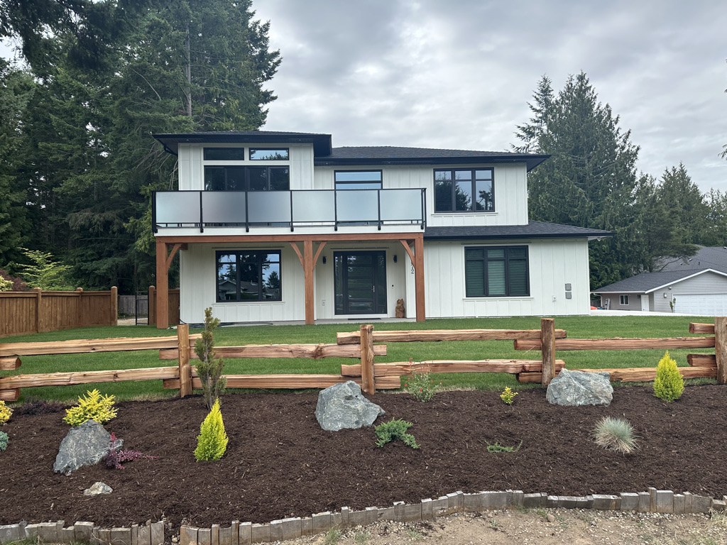 Completed two storey home renovation with new siding, balcony and landscaping