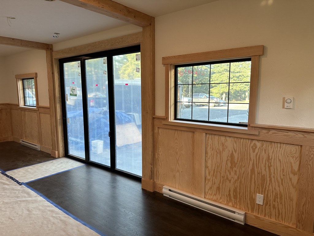 New addition interior with fir trim, wainscot panelling and a wide patio door