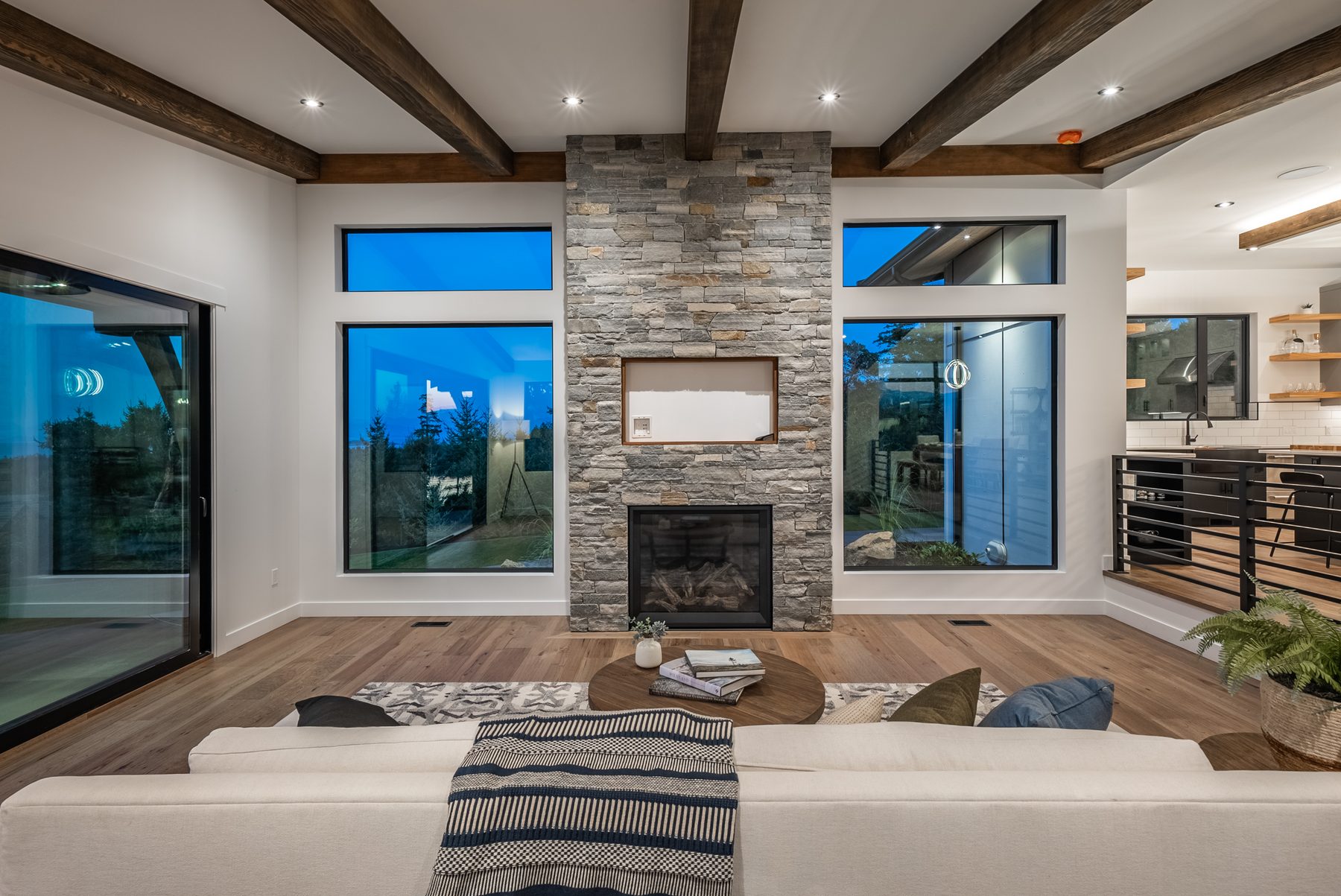 Great room in a custom home centred on a stone fireplace