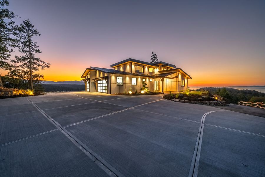 Modern custom home exterior glowing at night