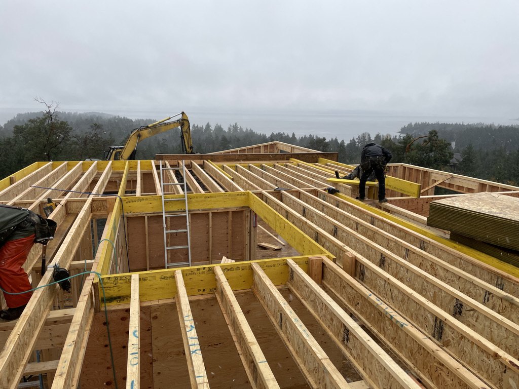 Roof framing and floor joists going on during a wet Vancouver Island winter