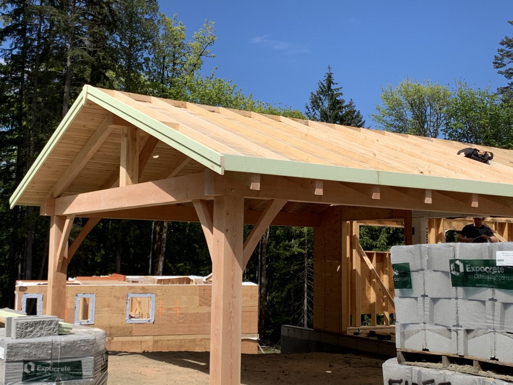 Completed timber pavilion with a fir ceiling and heavy post and beam frame