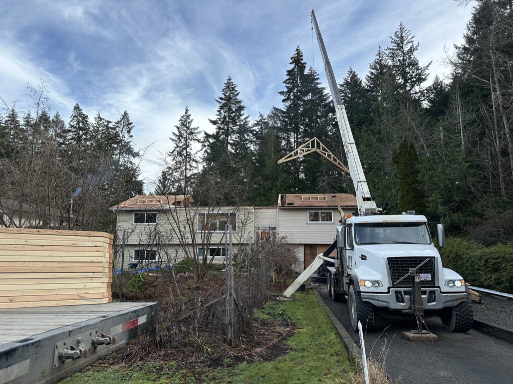 Crane lifting roof trusses into place on a VIP Homes build