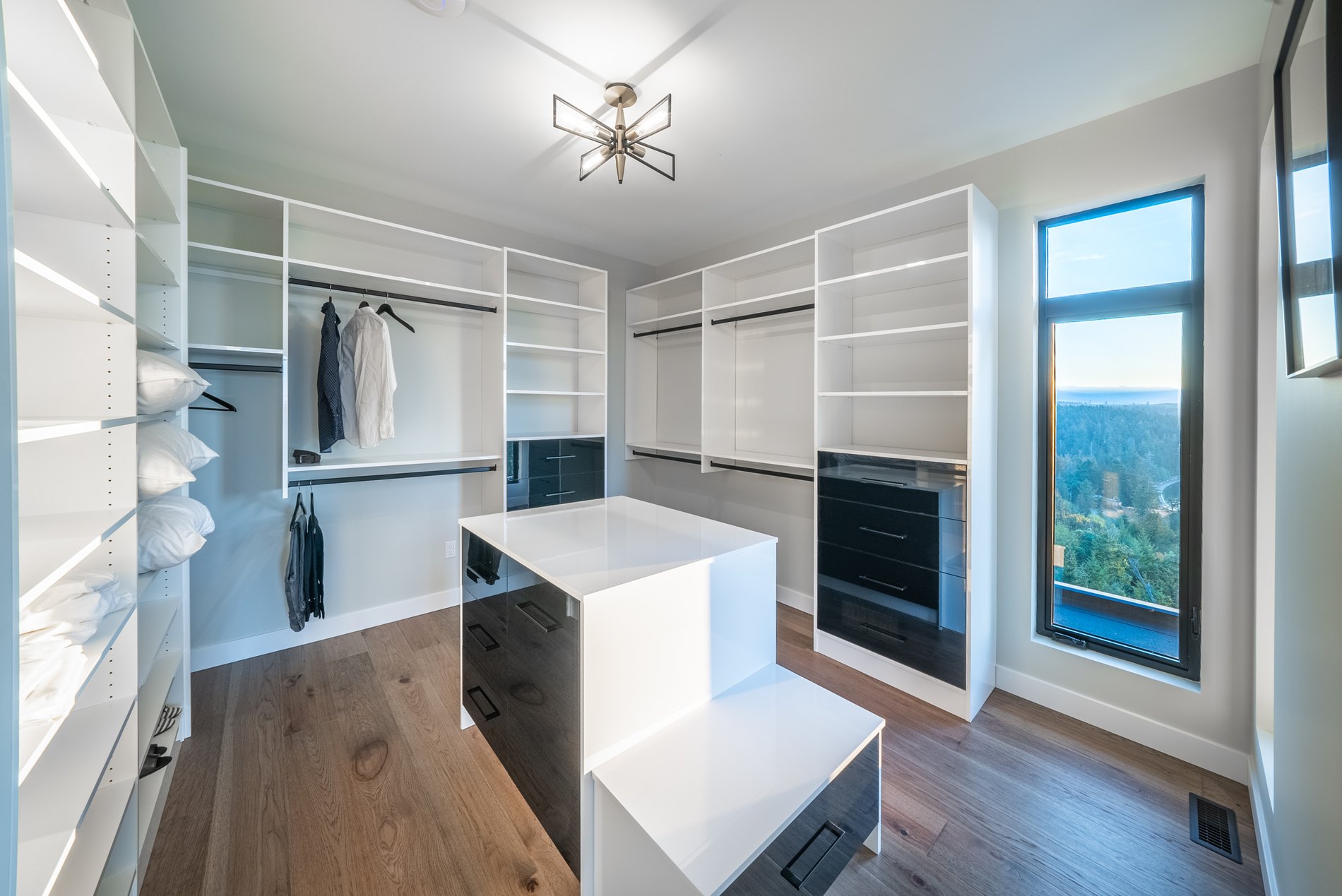 Walk-in closet with a central island, open shelving and a window