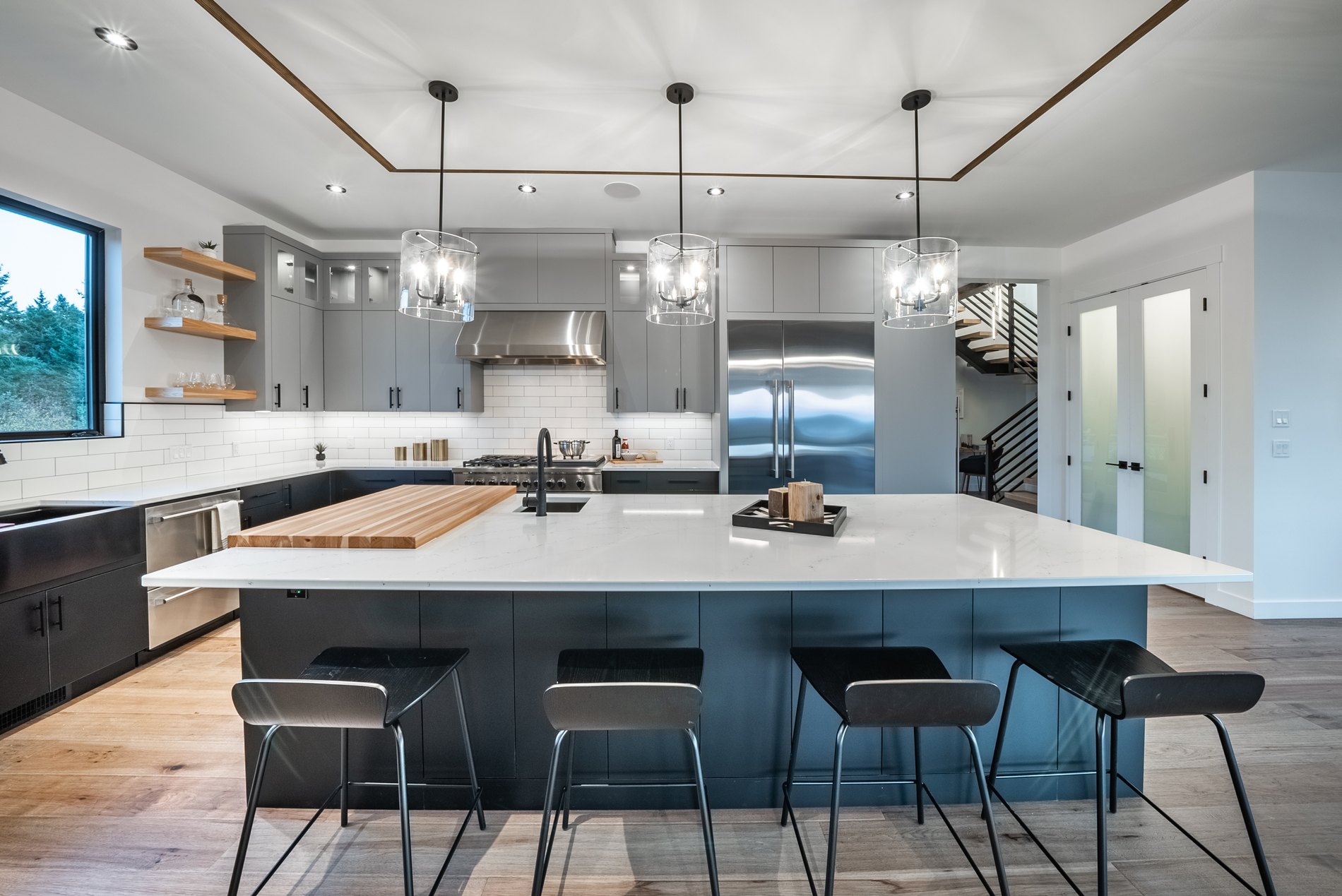 Kitchen with a large island, subway tile backsplash and stainless appliances