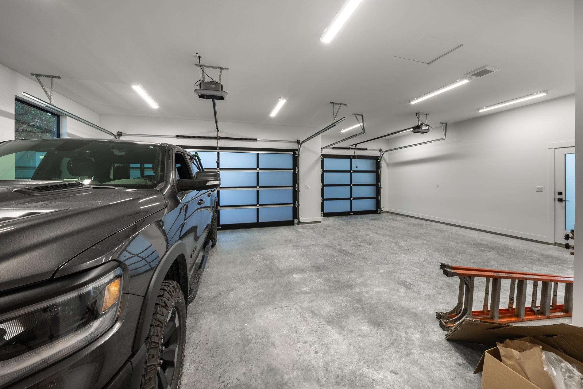 Finished garage interior with a polished slab and a truck parked inside